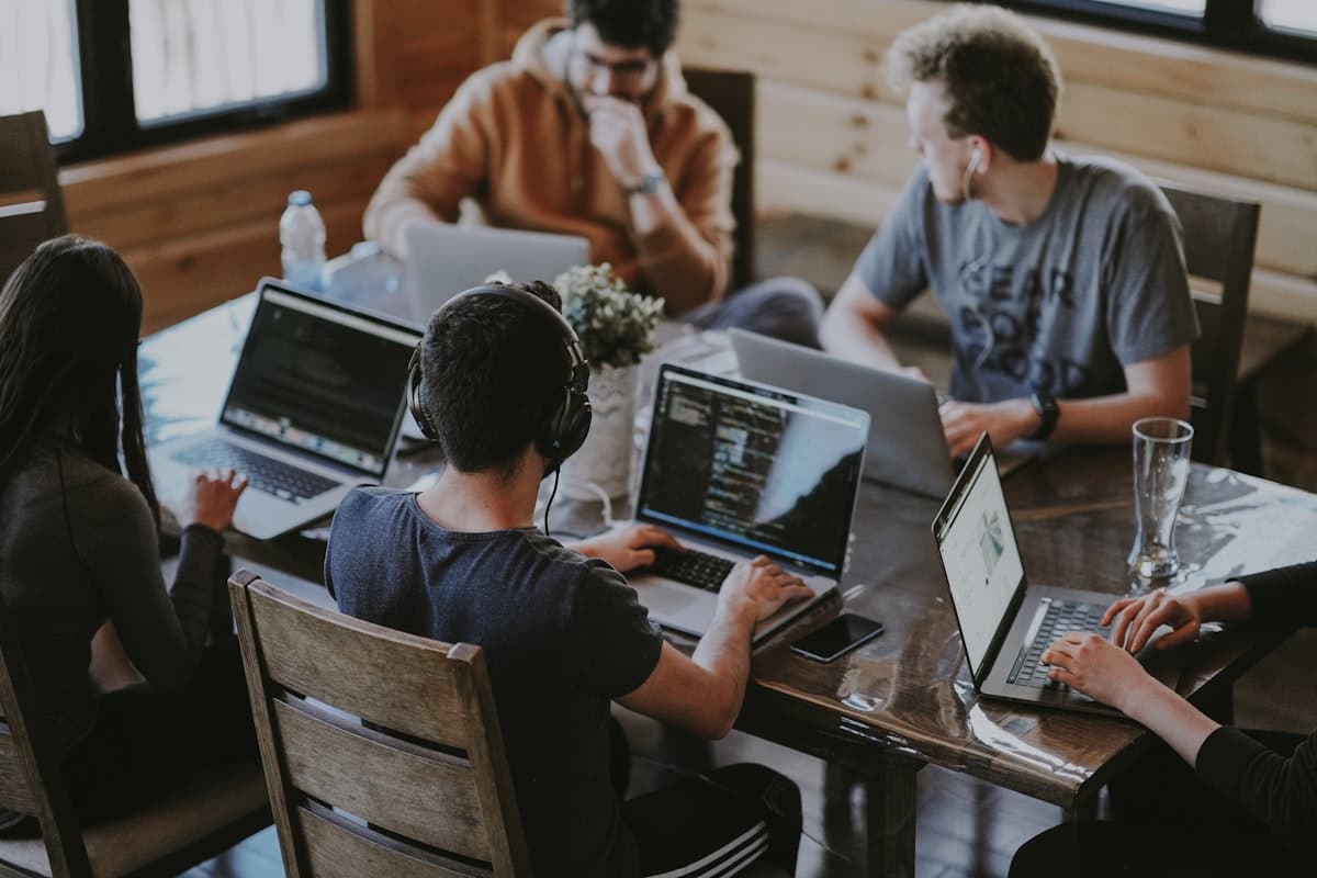 Équipe collaborant en réunion avec outils numériques